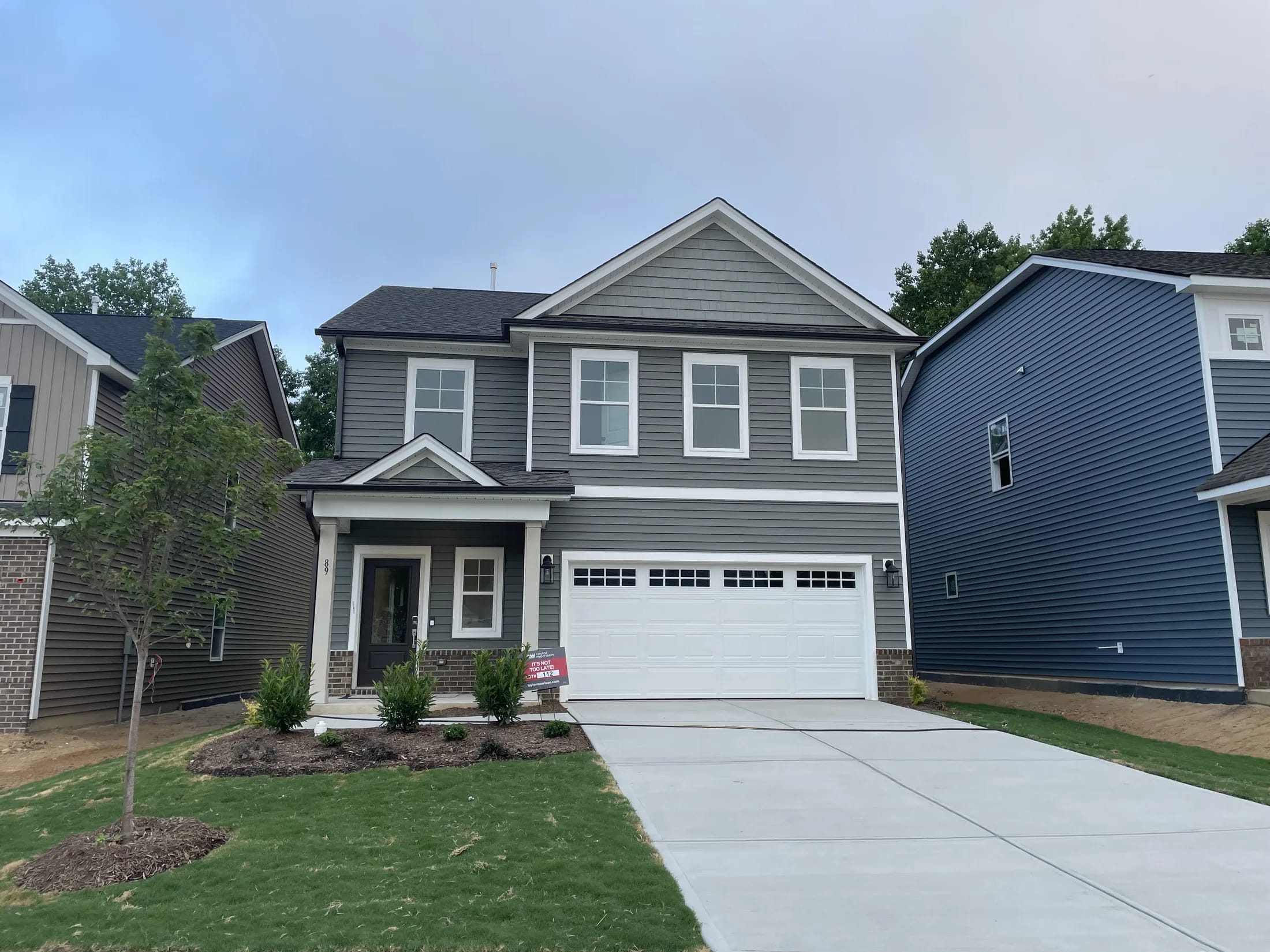 Gray home finished with horizontal lap siding and white trim.
